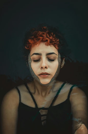 a woman with red hair wearing a black dress, an album cover, inspired by Elsa Bleda, trending on pexels, reflective faces, dreaming face, cyborg portrait, unconscious