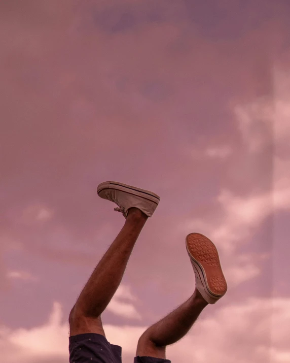 a man flying through the air while riding a skateboard, pexels contest winner, happening, orange / pink sky, feet posing, ☁🌪🌙👩🏾, brown skin like soil