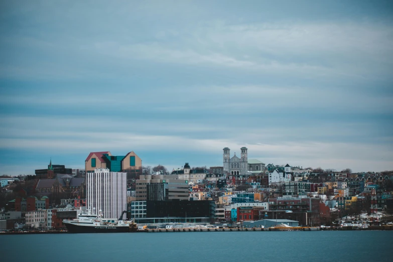 a large body of water with a city in the background, by Brian Snøddy, pexels contest winner, rhode island, seaside, slide show, multicoloured