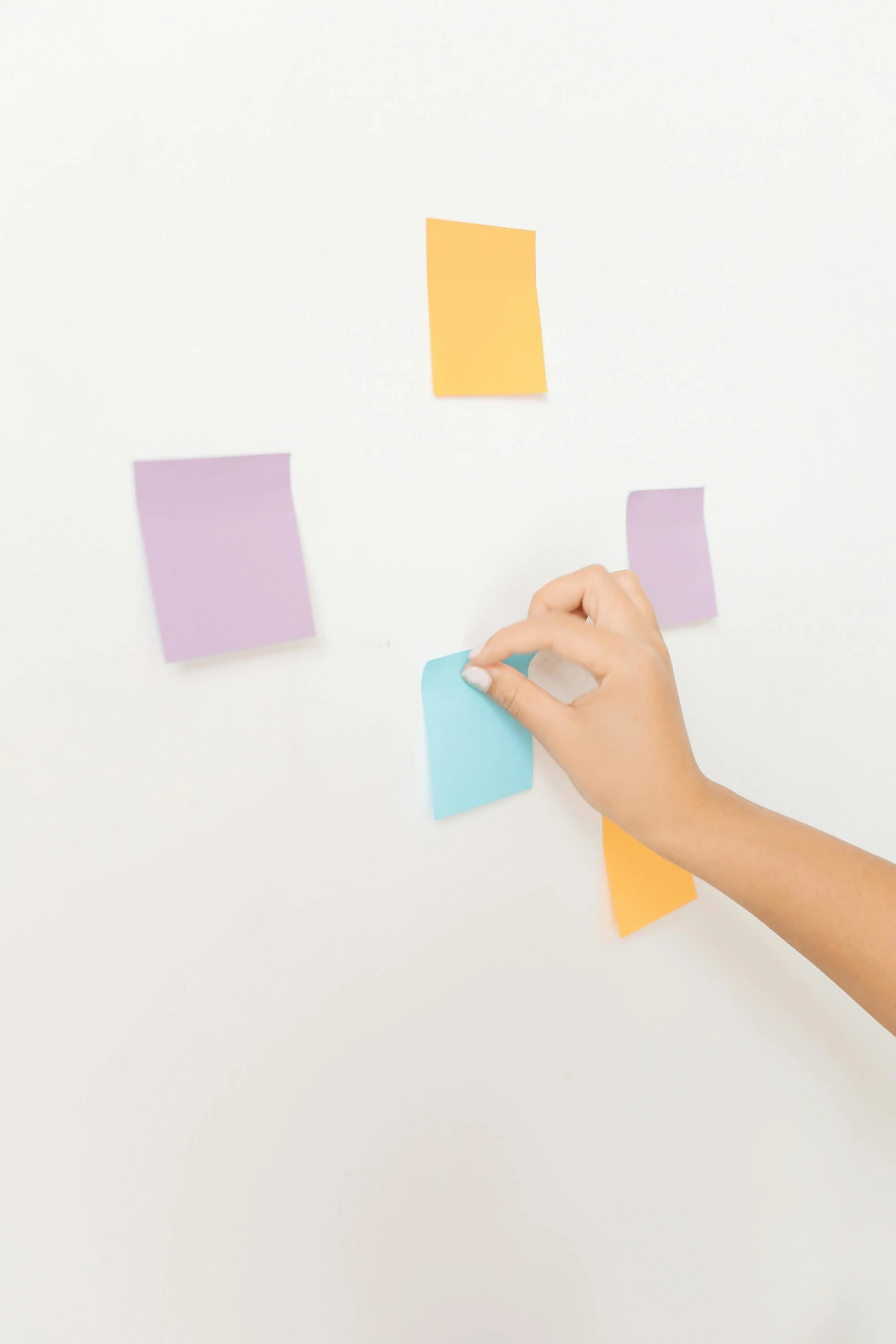 a woman standing in front of a wall covered in post it notes, set against a white background, square sticker, muted pastels, hands