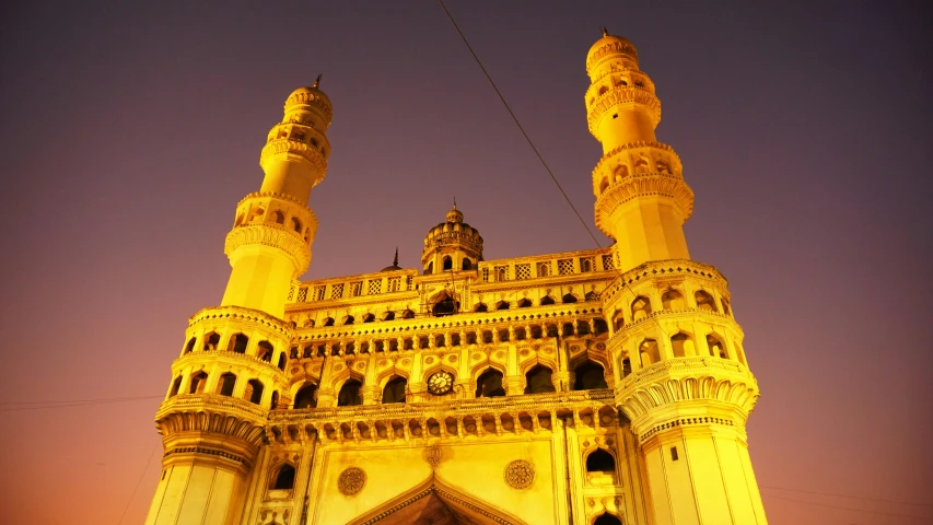 a tall building with a clock on the top of it, a marble sculpture, by Bholekar Srihari, pexels contest winner, art nouveau, with beautiful mosques, lit from bottom, square, pink