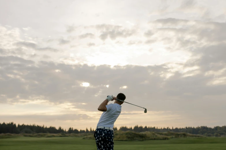 a man swinging a golf club on a cloudy day, unsplash contest winner, happening, evening lighting, avatar image, sydney hanson, profile image