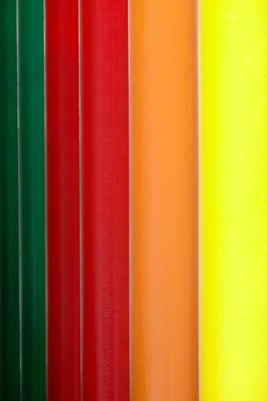 a group of colored pencils lined up in a row, by Doug Ohlson, plasticien, luminescent fabrics, red and yellow scheme, banners, bright green dark orange