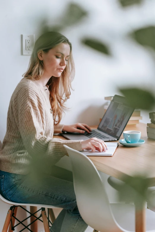 a woman sitting at a table with a laptop, trending on pexels, avatar image, casually dressed, award - winning, pastel'