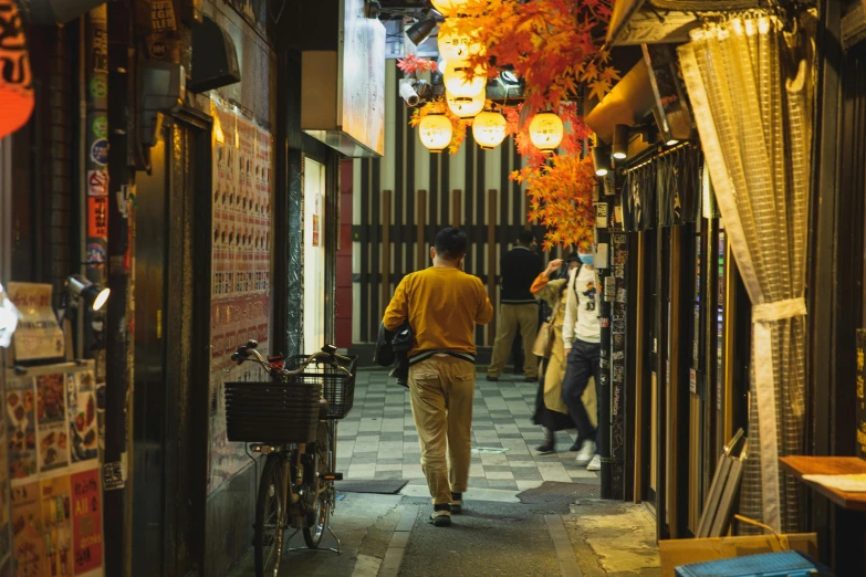 a man walking down a narrow alley way, inspired by Kanō Hōgai, pexels contest winner, ukiyo-e, yellow and ornage color scheme, taverns nighttime lifestyle, 🦩🪐🐞👩🏻🦳, japanese related with flowers