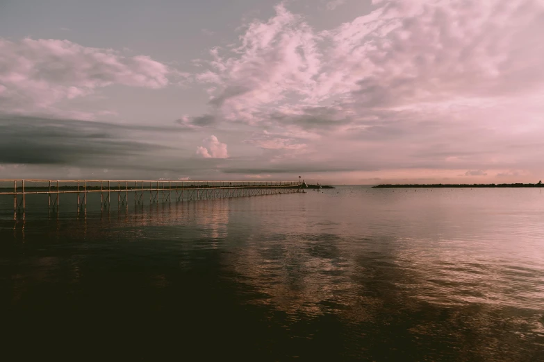 a large body of water under a cloudy sky, a picture, pexels contest winner, romanticism, faded pink, near a jetty, brown, tie-dye