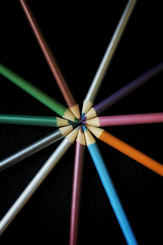 a group of colored pencils arranged in a circle, an album cover, by Doug Ohlson, pexels, precisionism, black chalk, metallic colors, deep colour\'s, group photo