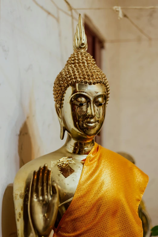 a close up of a statue of a person, gold decorations, health spa and meditation center, over the shoulder, religious imagery