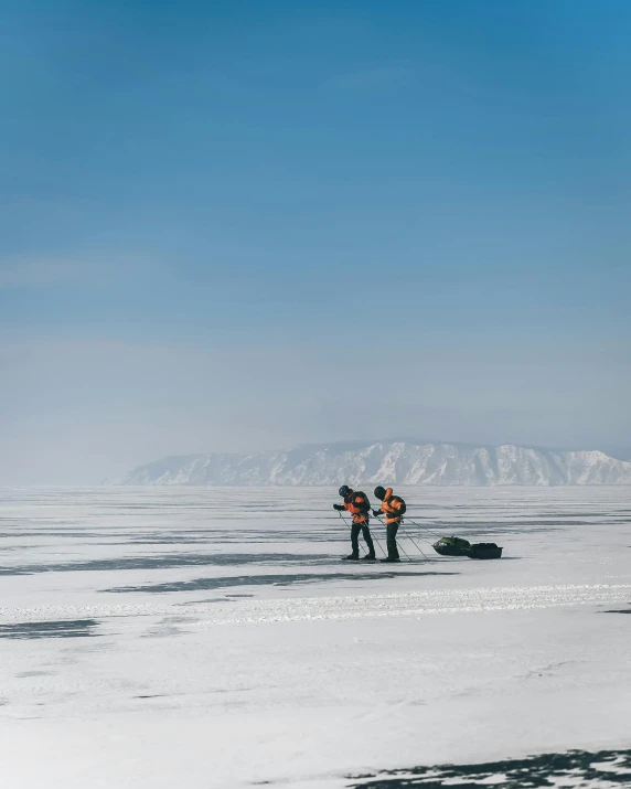 a couple of people standing on top of a snow covered field, near lake baikal, carrying survival gear, off - white collection, unsplash photography