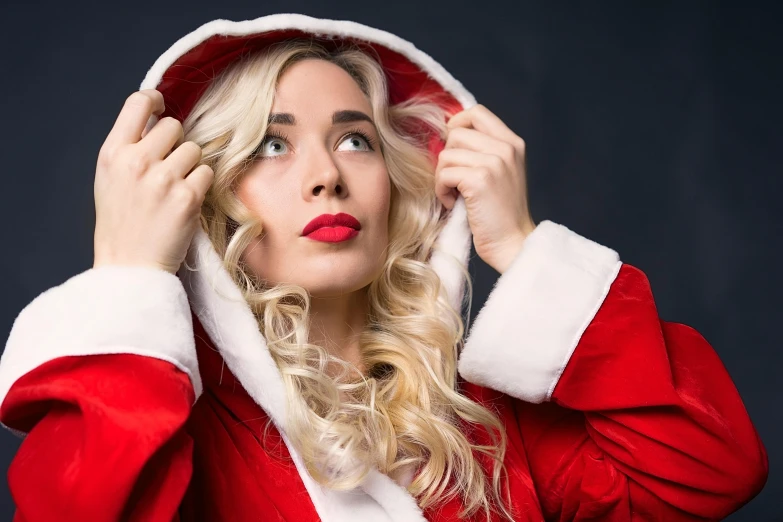 a close up of a person wearing a santa suit, an album cover, by Julia Pishtar, pexels, blonde and attractive features, goldilocks, surprising, 15081959 21121991 01012000 4k