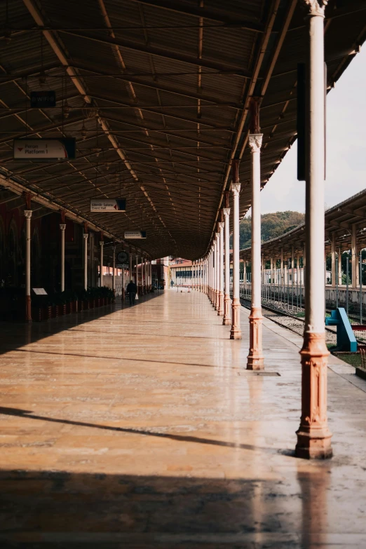 a train station with a train on the tracks, trending on unsplash, wet market street, inside a palace, deserted, pavilion