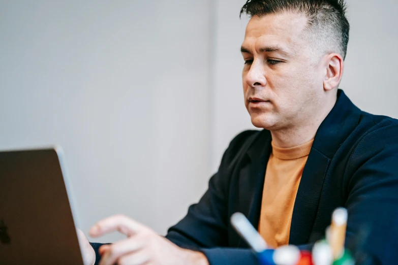 a man sitting in front of a laptop computer, a photo, by Jacqui Morgan, trending on pexels, temuera morrison, natasha tan maciej kuciara, no - text no - logo, profile image