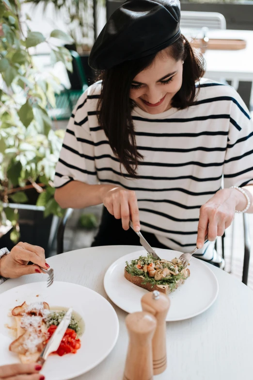 a couple of women sitting at a table with plates of food, pexels contest winner, happening, eating garlic bread, cutting a salad, sydney hanson, with seaweed