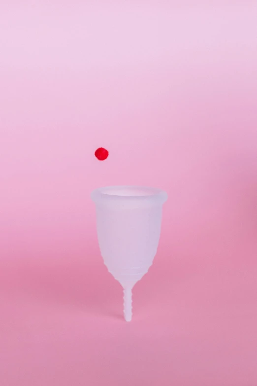 a plastic cup sitting on top of a pink surface, by Elsa Bleda, clown nose, surgical iv drip, female ascending, contracept