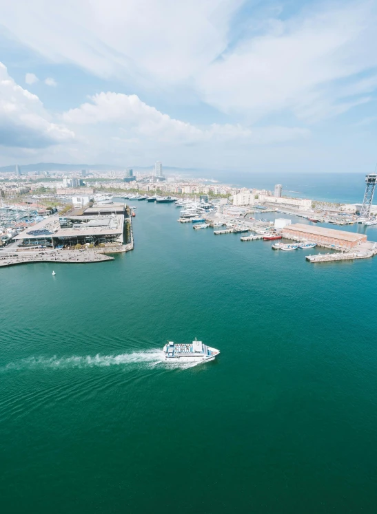 a large body of water with a boat in it, by Daniel Seghers, pexels contest winner, happening, in barcelona, aerial footage, harbour in background, thumbnail