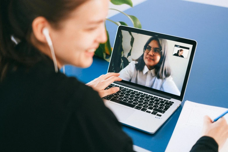 a woman sitting in front of a laptop on a desk, trending on pexels, hurufiyya, in meeting together, avatar image, thumbnail