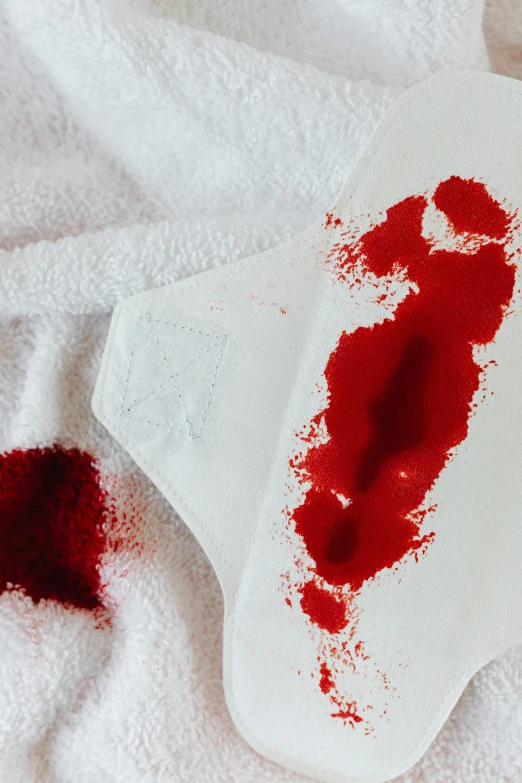 a white towel with a blood stain on it, trending on pexels, red hoods, red palette, scrape off