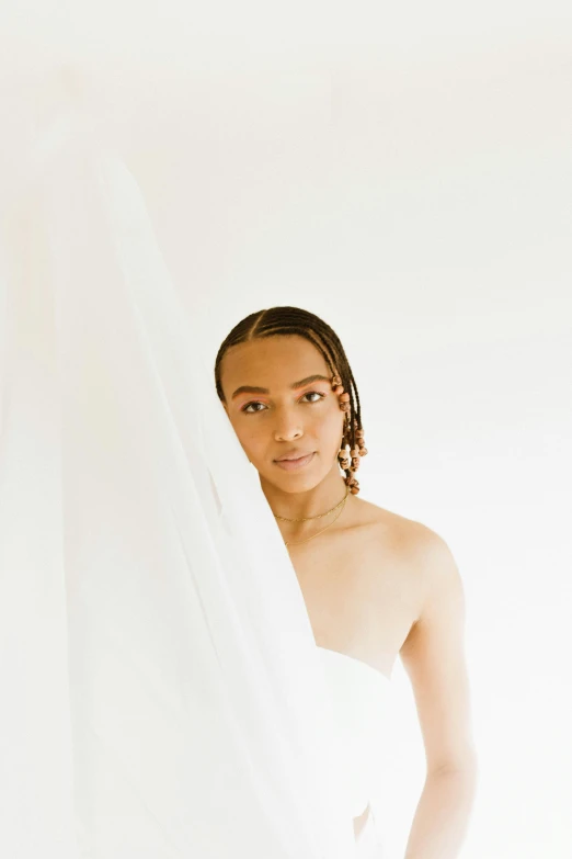 a woman in a wedding dress holding a veil, by Cosmo Alexander, visual art, ashteroth, in front of white back drop, long braided hair pulled back, white sheets