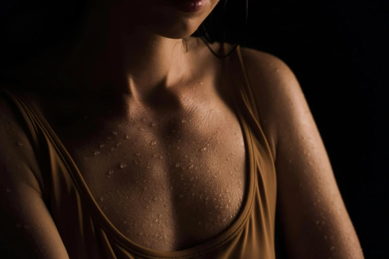 a close up of a woman with water on her face, an album cover, inspired by Elsa Bleda, trending on pexels, australian tonalism, sport bra and shirt, chest coverd, sweating, light tan