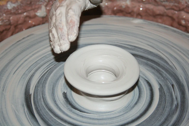 a person throwing a bowl on a potter's wheel, a marble sculpture, inspired by Hendrik Gerritsz Pot, trending on unsplash, process art, 15081959 21121991 01012000 4k, low detail, islamic, tie-dye