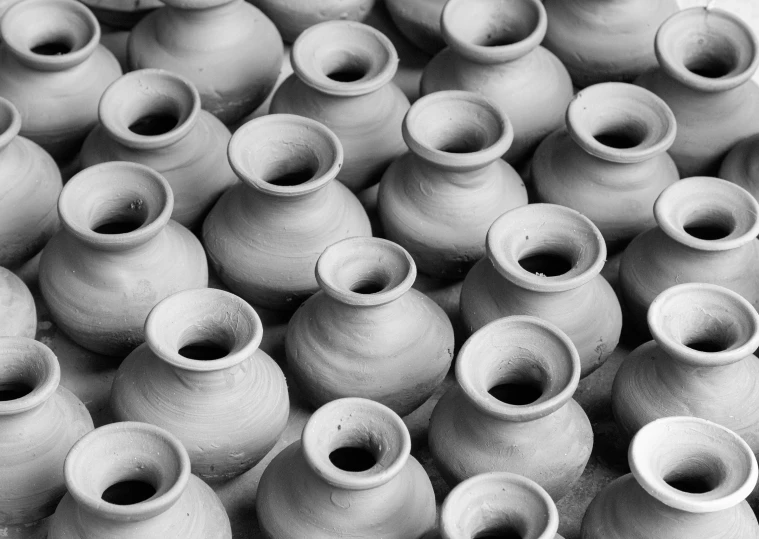 a bunch of vases sitting on top of each other, a black and white photo, unsplash, process art, made of clay, vietnam, valves, pot