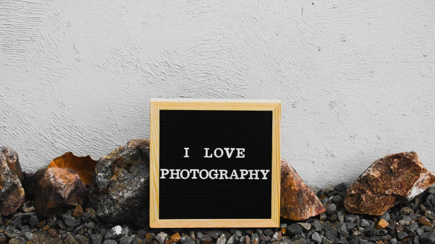 a sign that says i love photography next to some rocks, by Julia Pishtar, art photography, photographic print, wood print, lightbox, - i