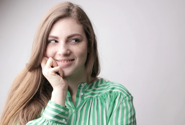 a woman posing for a picture with her hand on her chin, a picture, trending on pixabay, wearing stripe shirt, light green tone beautiful face, 15081959 21121991 01012000 4k, portrait of white teenage girl
