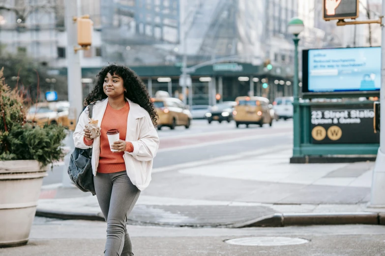 a woman walking down the street with a cup of coffee, trending on pexels, happening, new york city, essence, fullbody photo, diverse