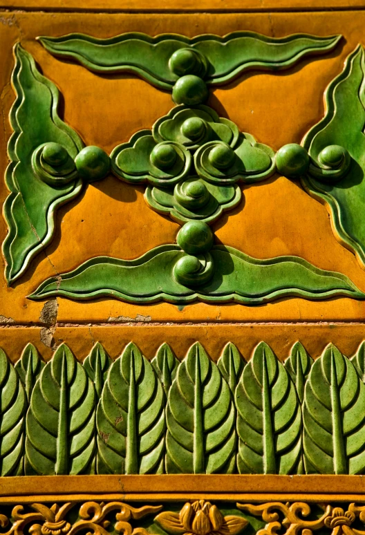 a close up of a decorative design on a wall, green tonalities, terracotta, rectangle, exterior