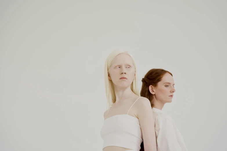 a couple of women standing next to each other, inspired by Vanessa Beecroft, aestheticism, albino white pale skin, on a pale background, looking across the shoulder, eora