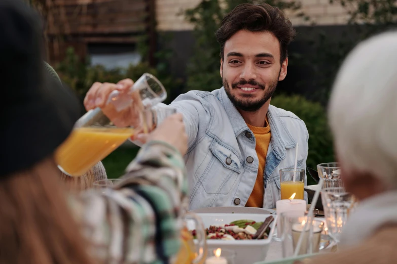 a man pouring orange juice into a glass, pexels contest winner, renaissance, people outside eating meals, avatar image, rooftop party, 2 4 - year - old man