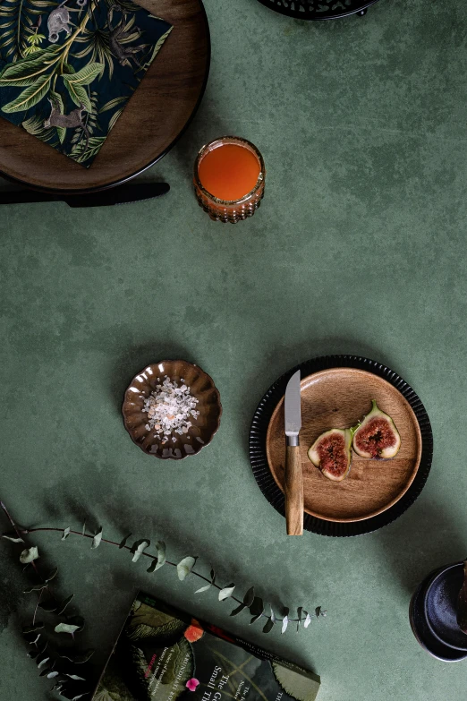 a table topped with plates and bowls of food, a still life, dark green tones, detailed product image, lifestyle, ginger