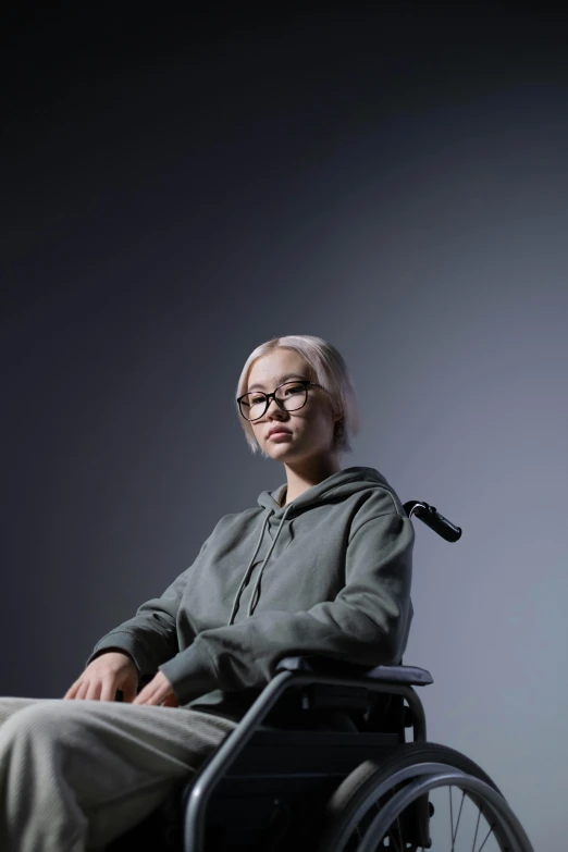 a woman sitting in a wheelchair in a dark room, by Jang Seung-eop, hyperrealism, nvidia promotional image, hong june hyung, on grey background, jesper esjing