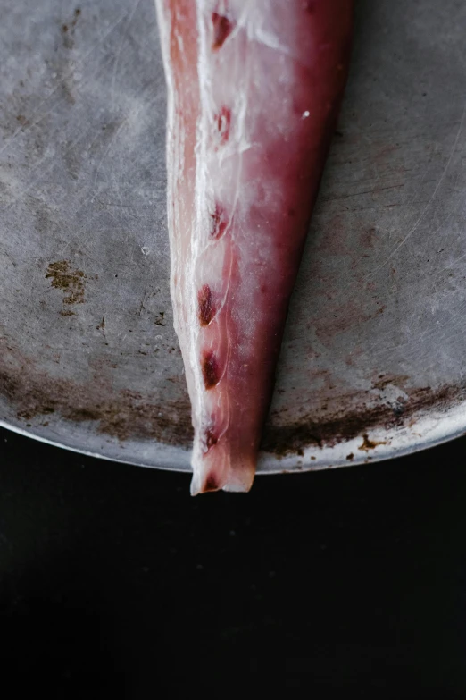 a piece of meat sitting on top of a pan, a picture, long flowing fins, hegre, maroon, f / 2 0