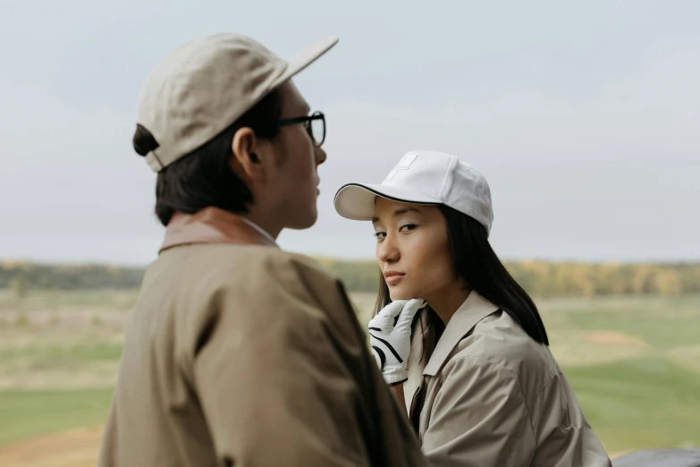 a man and a woman standing next to each other, pexels contest winner, wearing a baseball hat, asian features, off - white collection, sydney park