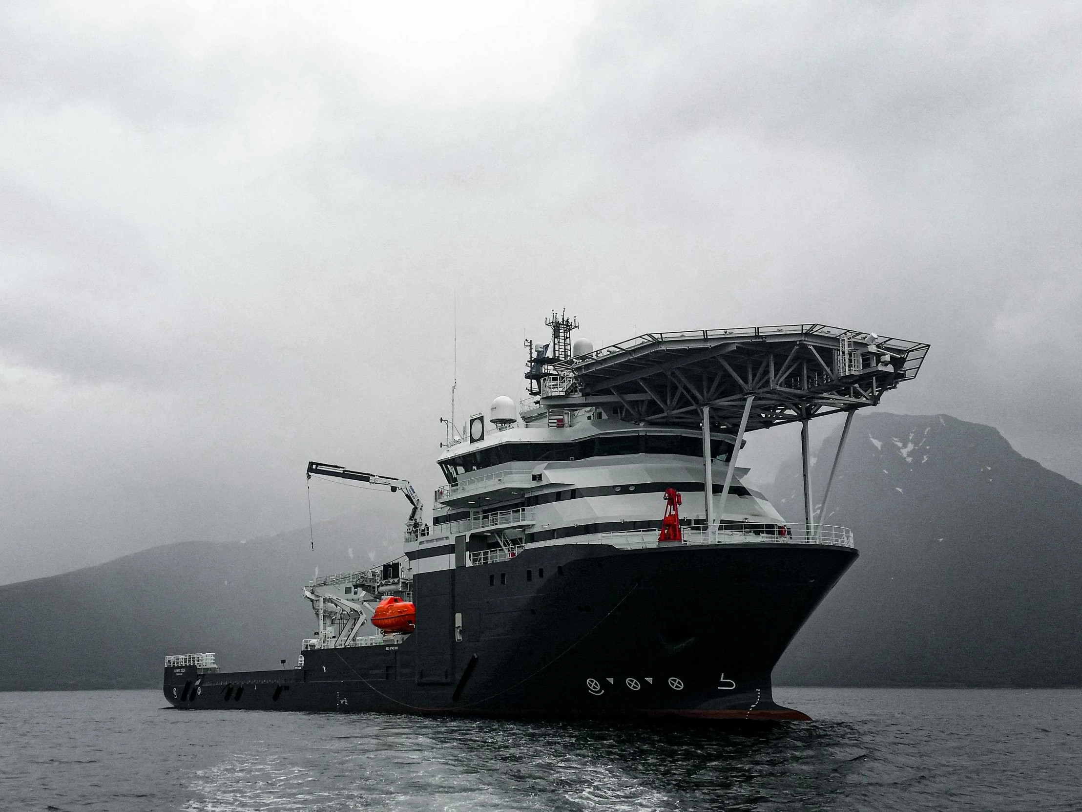 a large boat floating on top of a body of water, very deep sea