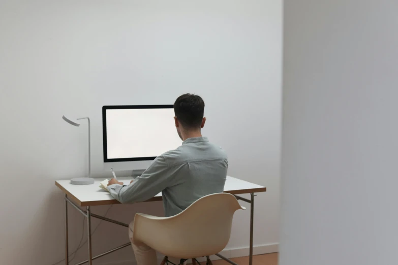 a man sitting at a desk in front of a computer, a computer rendering, pexels, sitting in an empty white room, ignant, colour corrected, everything fits on the screen