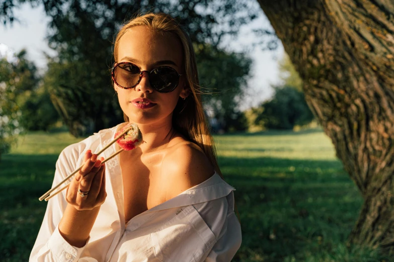 a woman in a white shirt smoking a cigarette, by Julia Pishtar, trending on pexels, having a picnic, woman with rose tinted glasses, sydney sweeney, she is easting a peach