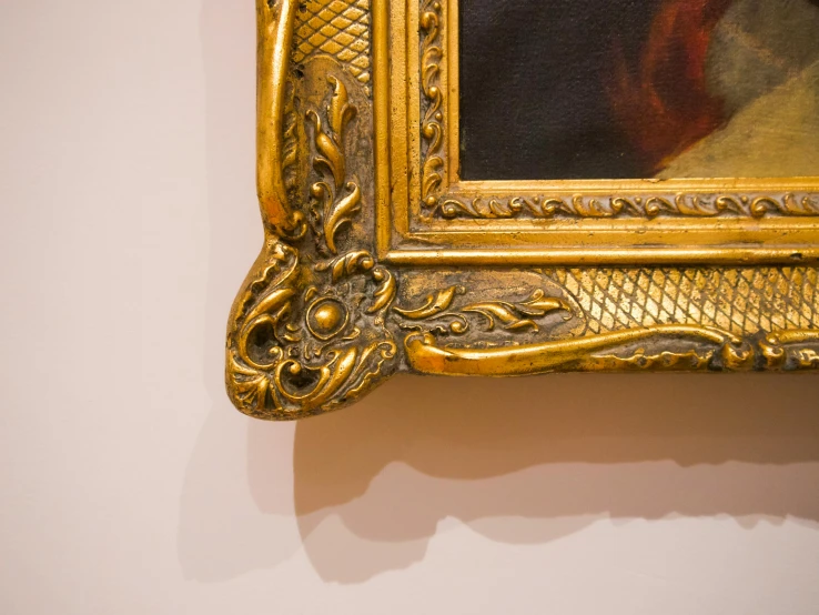 a close up of a painting on a wall, inspired by Frederic Leighton, unsplash, visual art, golden frame, courtesy of moma, van dyck, square pictureframes