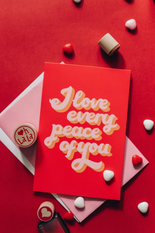 a red card that says i love every piece of you, by Julia Pishtar, peaceful mood, bubble gum, full product shot, flowing lettering