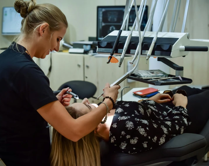 a woman getting her teeth examined by a dentist, by Meredith Dillman, pexels contest winner, lachlan bailey, panoramic shot, student, thumbnail