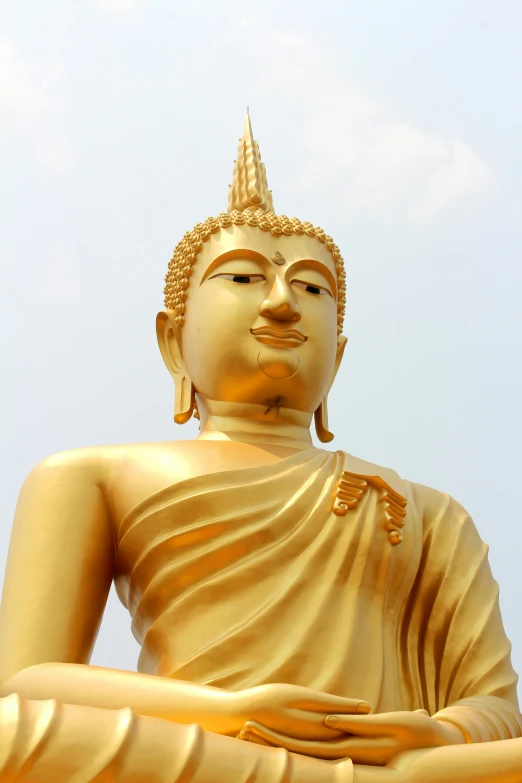 a golden buddha statue sitting on top of a lush green field, bangkok townsquare, avatar image, medium close shot, image
