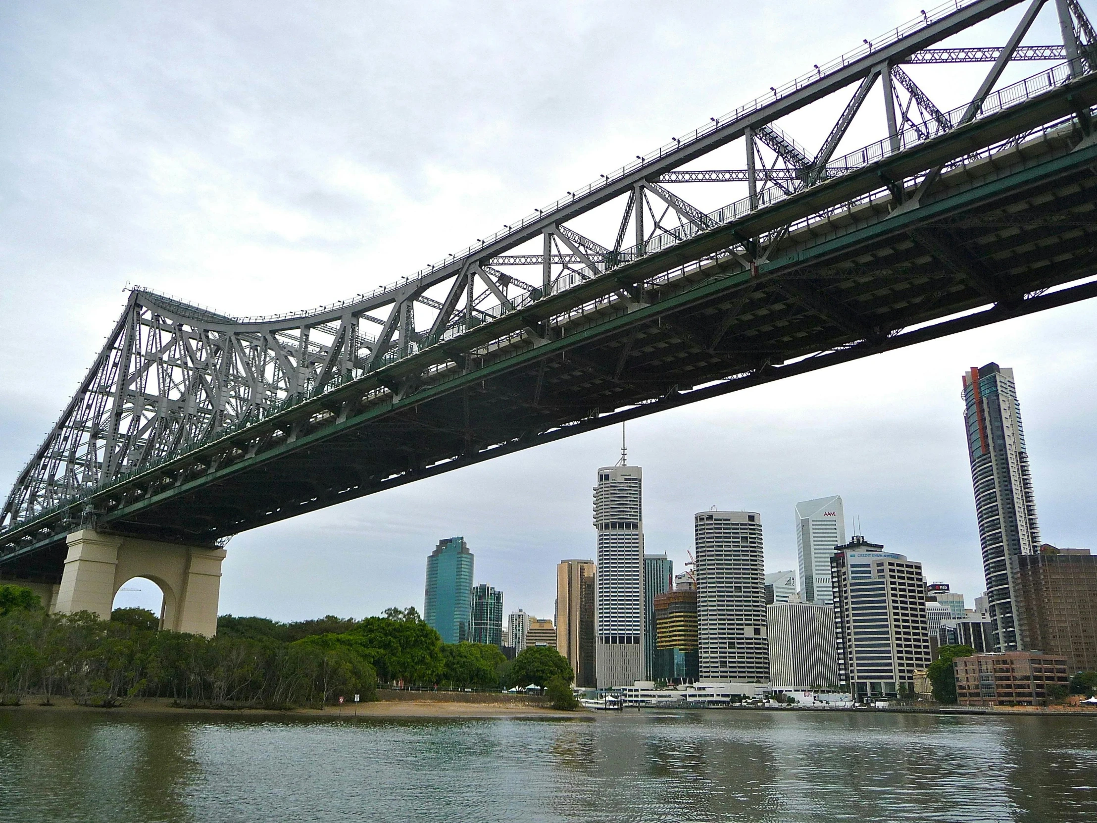 a bridge over a body of water with a city in the background, a photo, lachlan bailey, slide show, high rise buildings, plus-sized