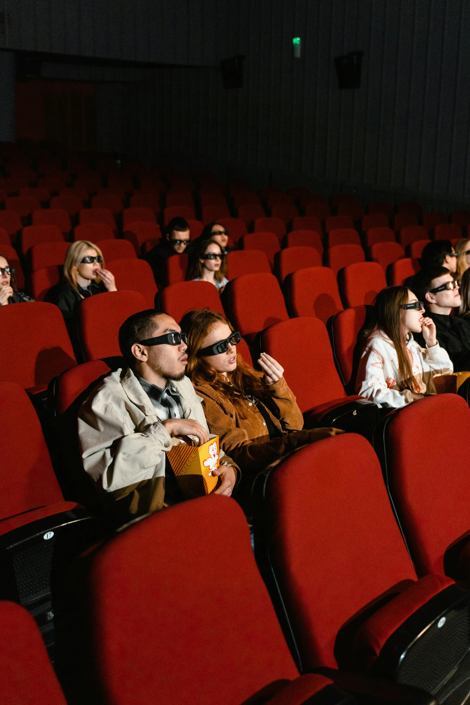 a group of people sitting in a theater watching a movie, a hologram, trending on pexels, hyperrealism, 3 d goggles, imdb, ( ( theatrical ) ), movie cover