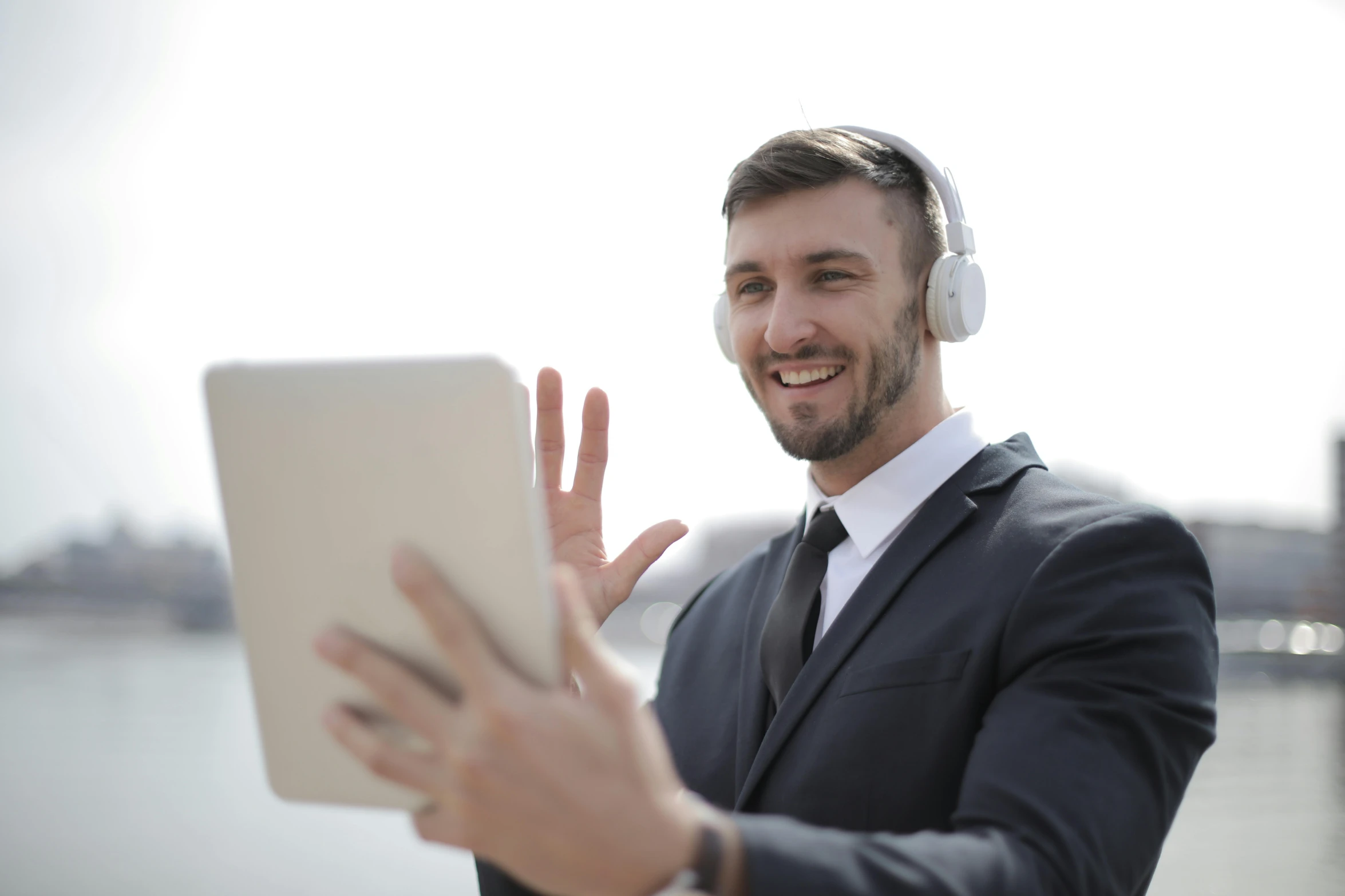 a man in a suit and headphones using a tablet, trending on pexels, waving, avatar image, high resolution image, meme format