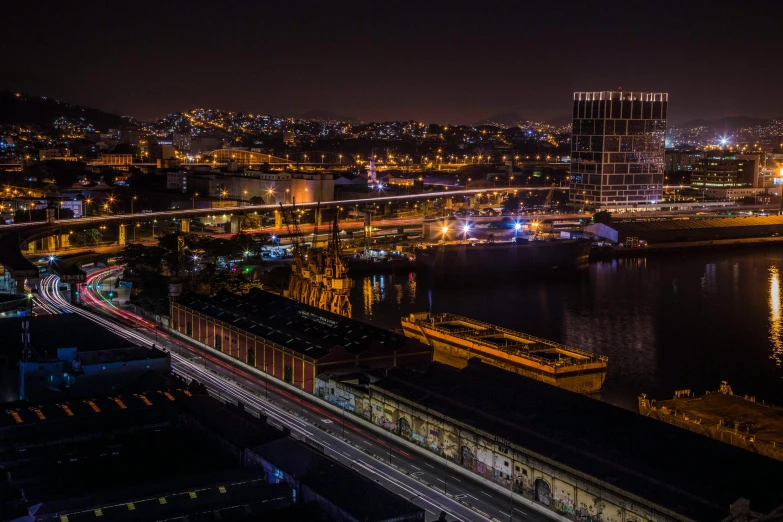 an aerial view of a city at night, a matte painting, by Peter Churcher, pexels contest winner, shipping docks, sydney, liege, gigapixel photo