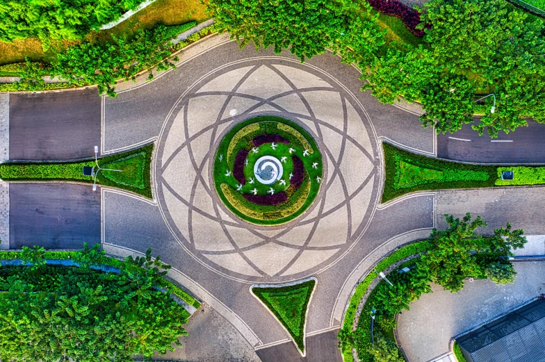 an aerial view of a roundabout surrounded by trees, a mosaic, by Sebastian Vrancx, pexels contest winner, celestial gardens, dimensional portal, sundial, panoramic photography
