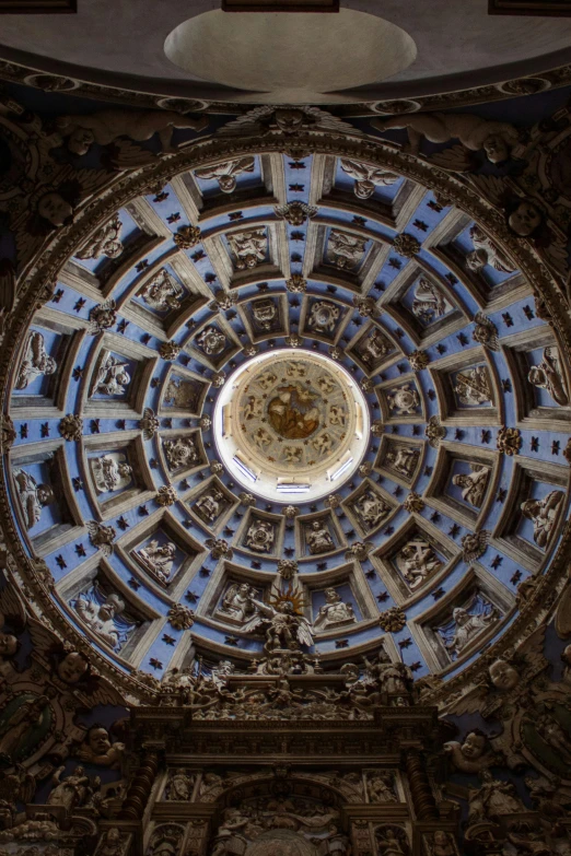 a view looking up at the ceiling of a building, an album cover, inspired by Gian Lorenzo Bernini, baroque, in the middle of round ruins, seville, 8 k intricate detail, lit from above