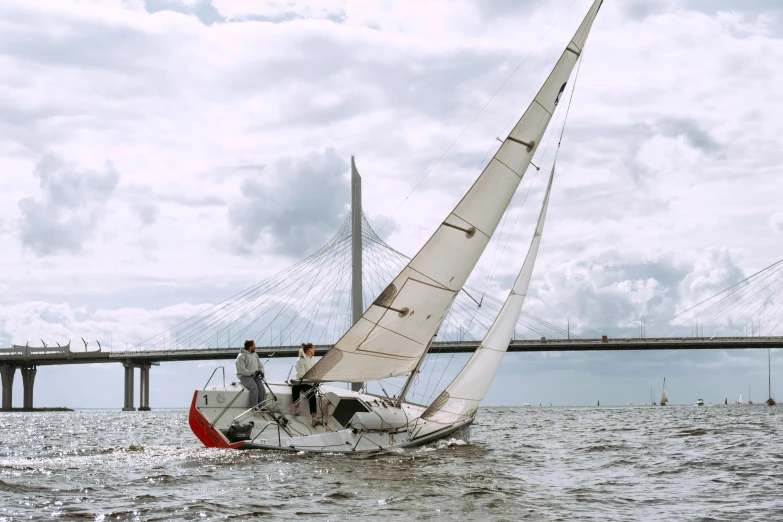 a sailboat in the water with a bridge in the background, spit flying from mouth, profile image, ignant, camaraderie