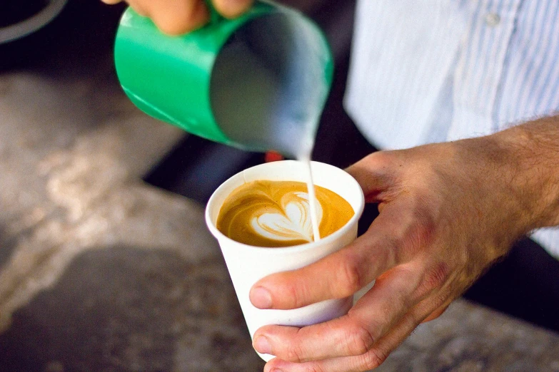 a person pouring milk into a cup of coffee, by Joe Bowler, al fresco, 9 9 designs, no cropping, cast